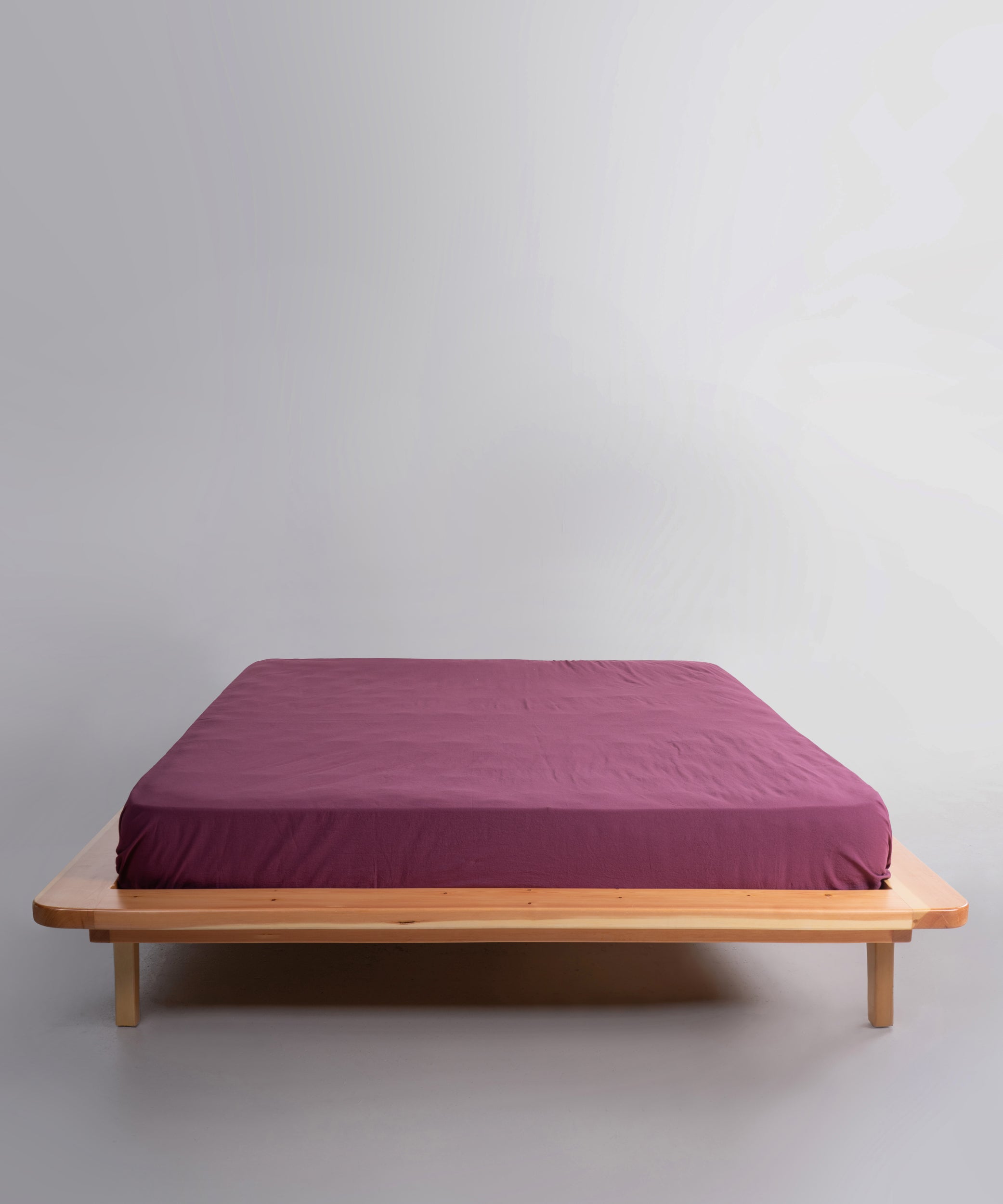 Stonewashed 100% cotton fitted sheet in Raspberry, offering a soft, breathable and relaxed finish. Designed for UK and US beds with deep fit options for a secure and stylish look.