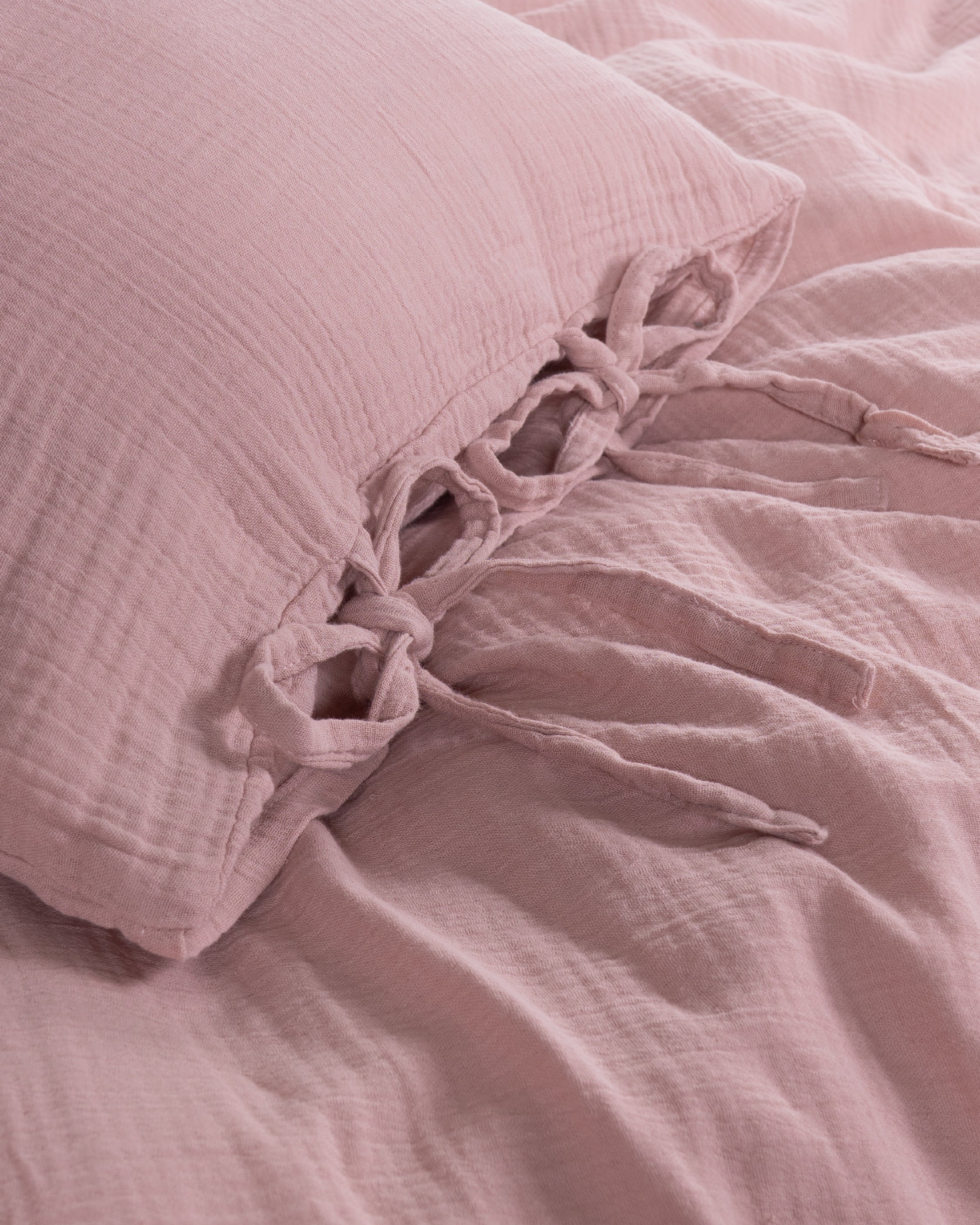 Close-up of tie detail and envelope closure on Esse Old Rose muslin pillowcase – Limasso London