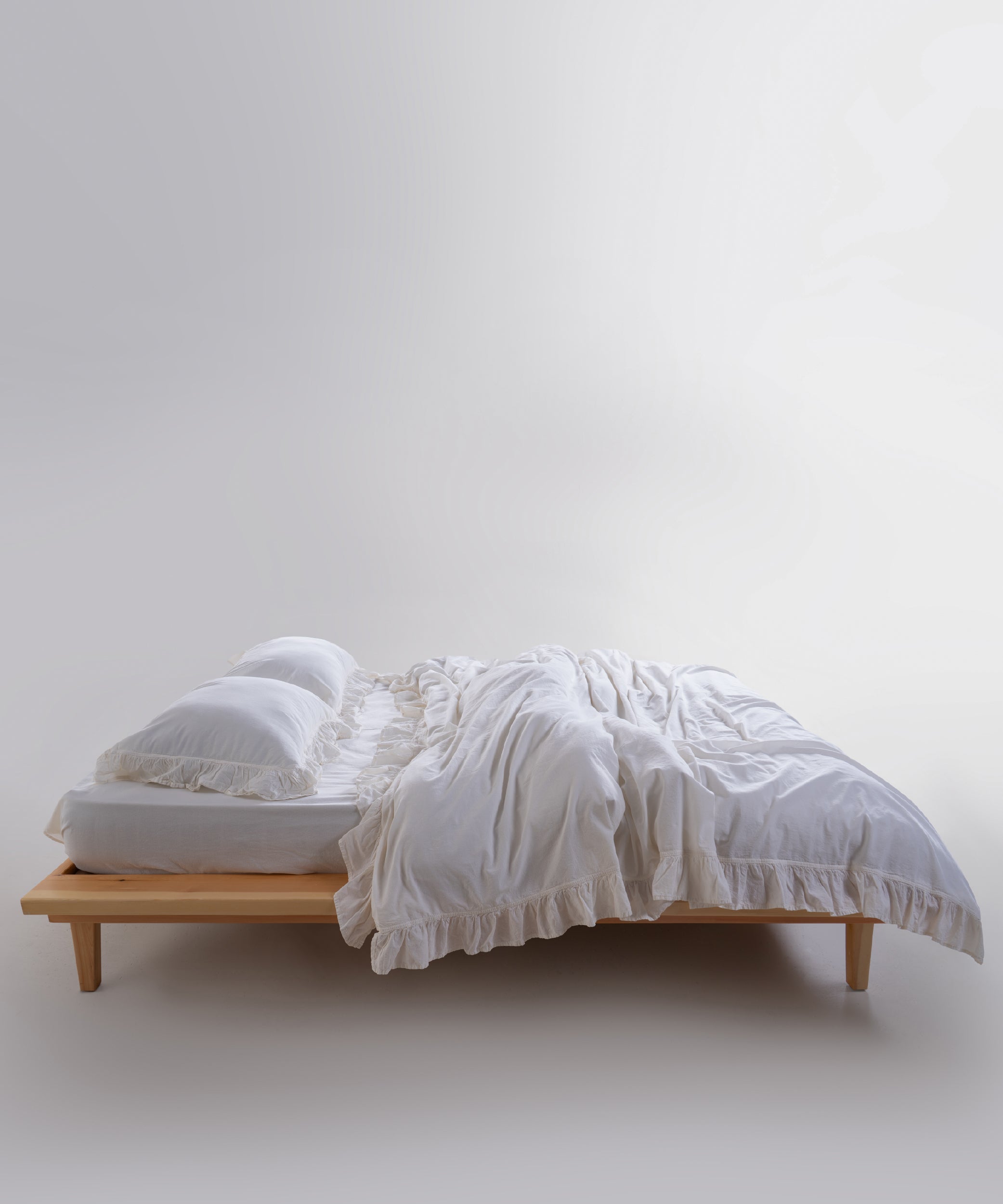 Stonewashed breathable bedding with elegant ruffle detailing for a calm, hotel-style bedroom.