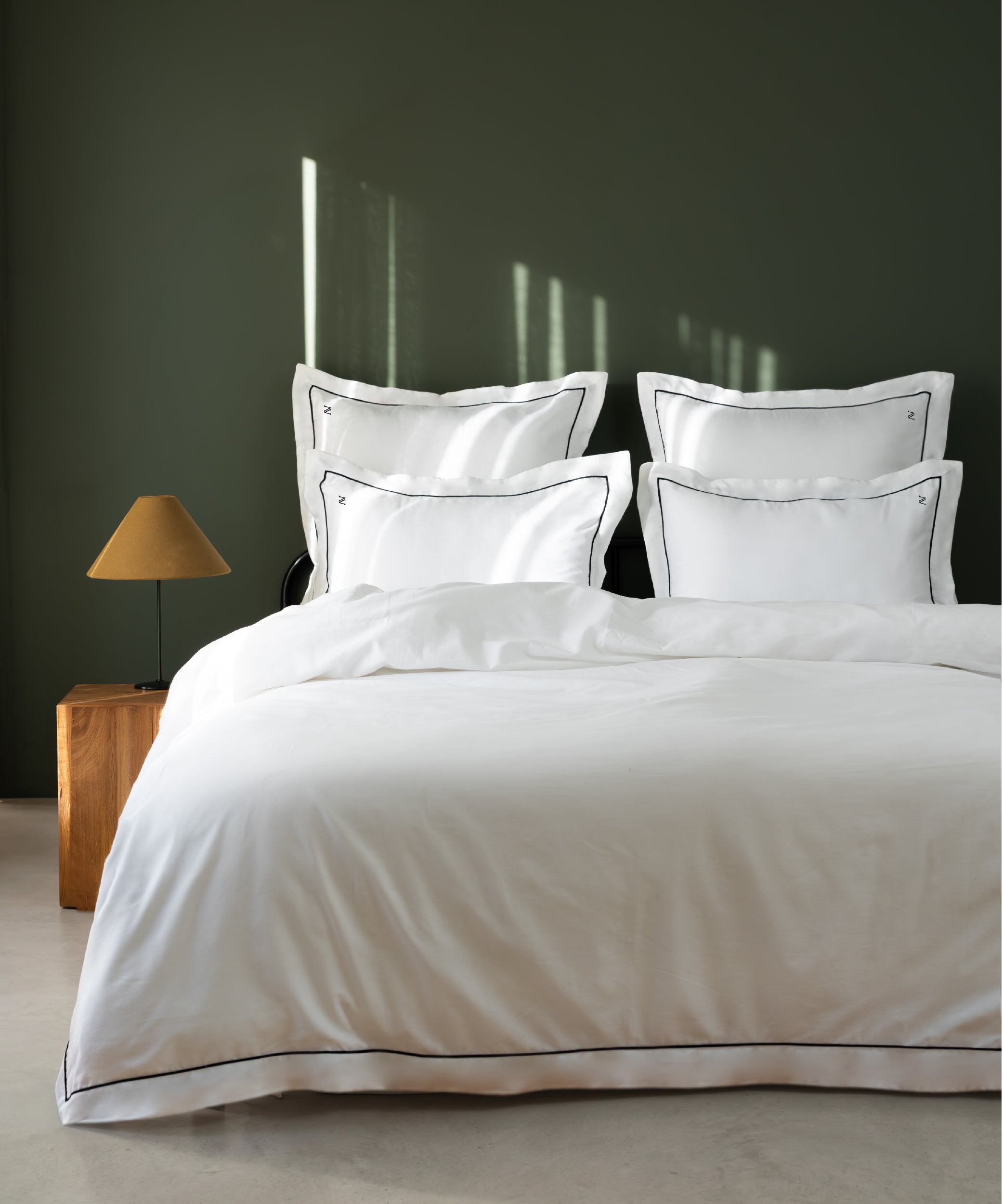 Luxury Cotton Sateen Oxford Duvet Cover Set with black contrast piping in a dark olive hotel-style bedroom – Limasso London