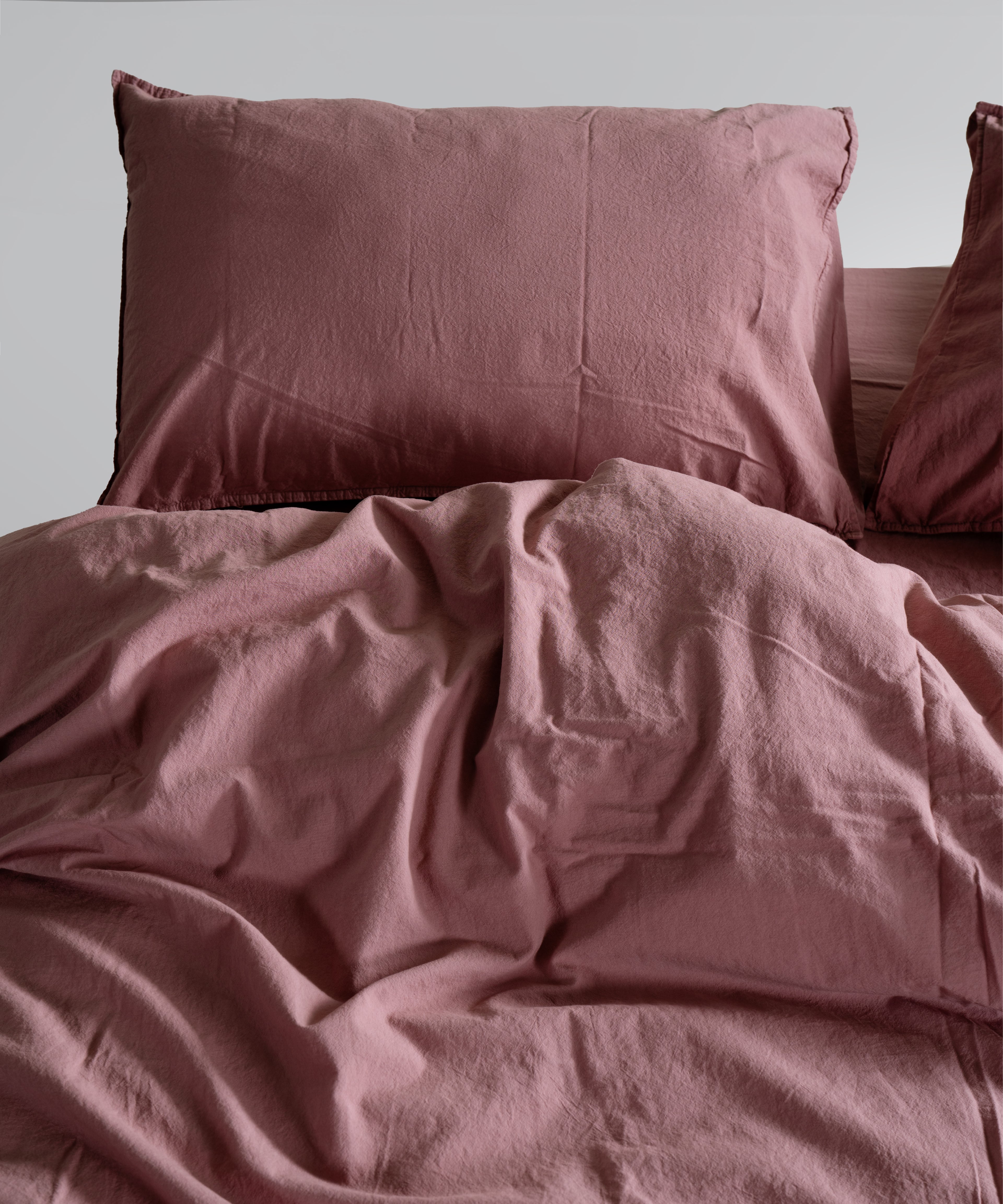 Old Rose pillowcases styled on bed to add a calm, cosy and elegant touch. Stonewashed cotton texture creates a relaxed, premium finish.