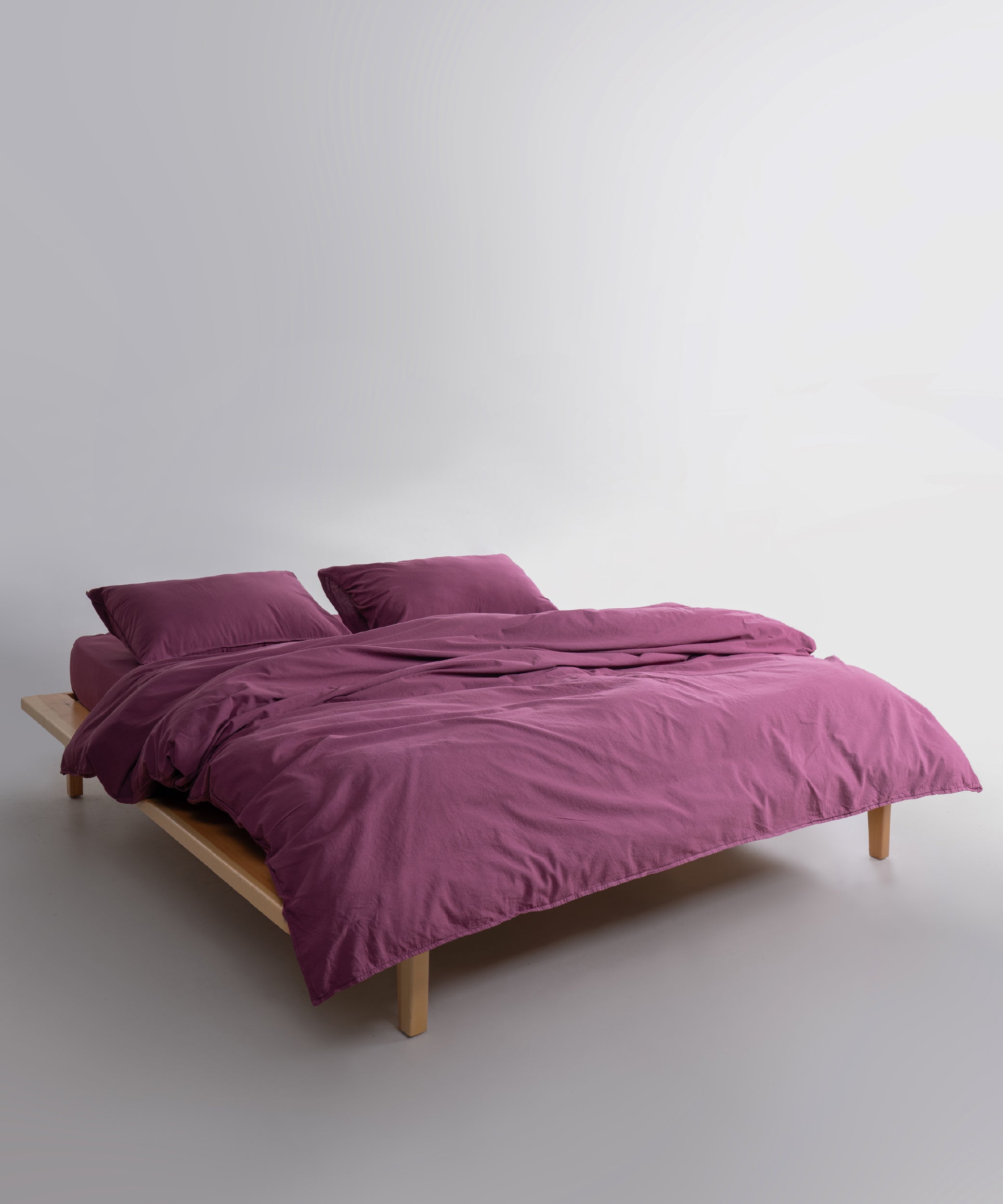 Raspberry stonewashed cotton duvet cover set styled in a modern bedroom, soft breathable natural cotton bedding for UK and US homes.