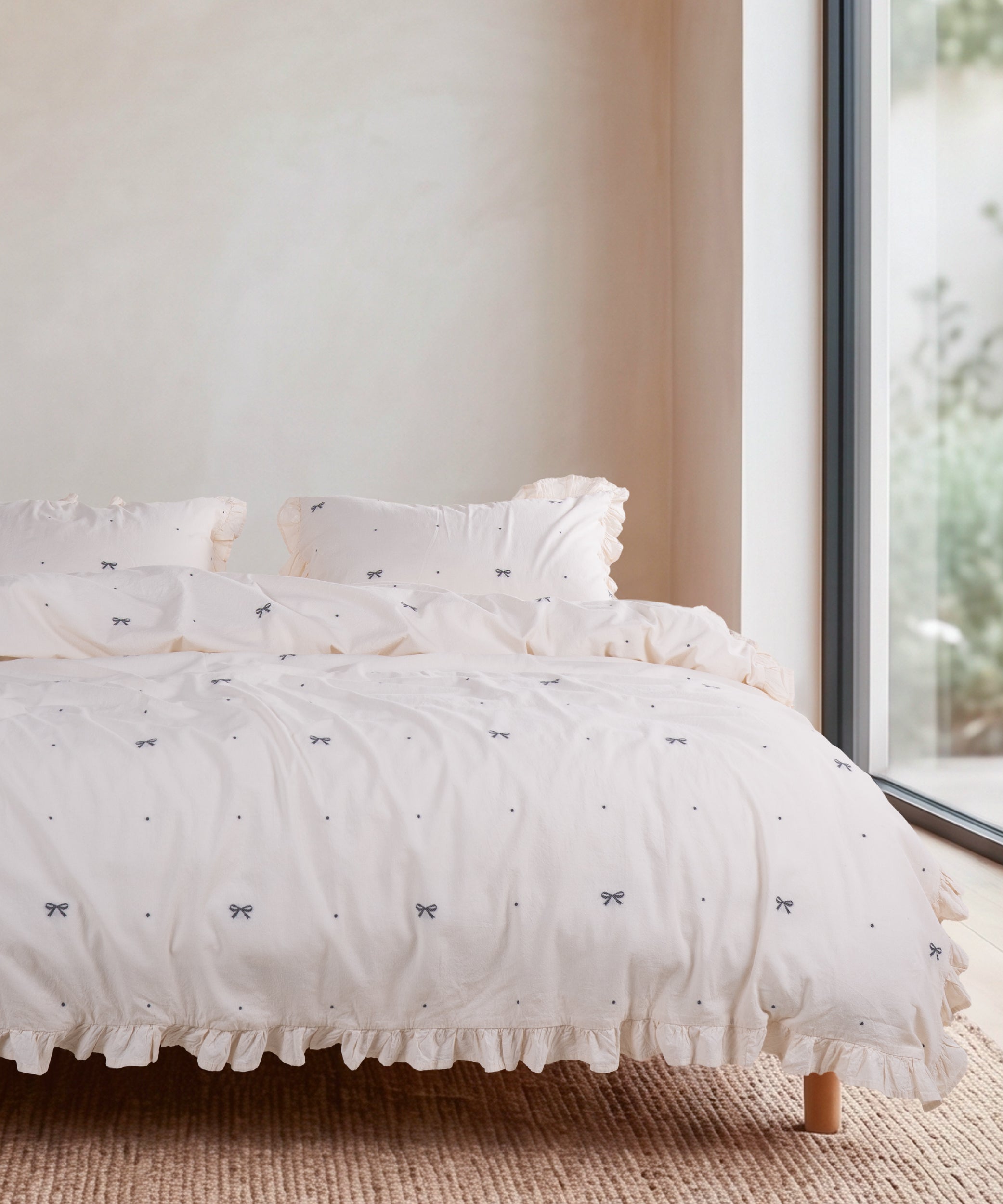 Cream 100% cotton duvet cover set with ribbon pattern styled on a bed – Limasso London