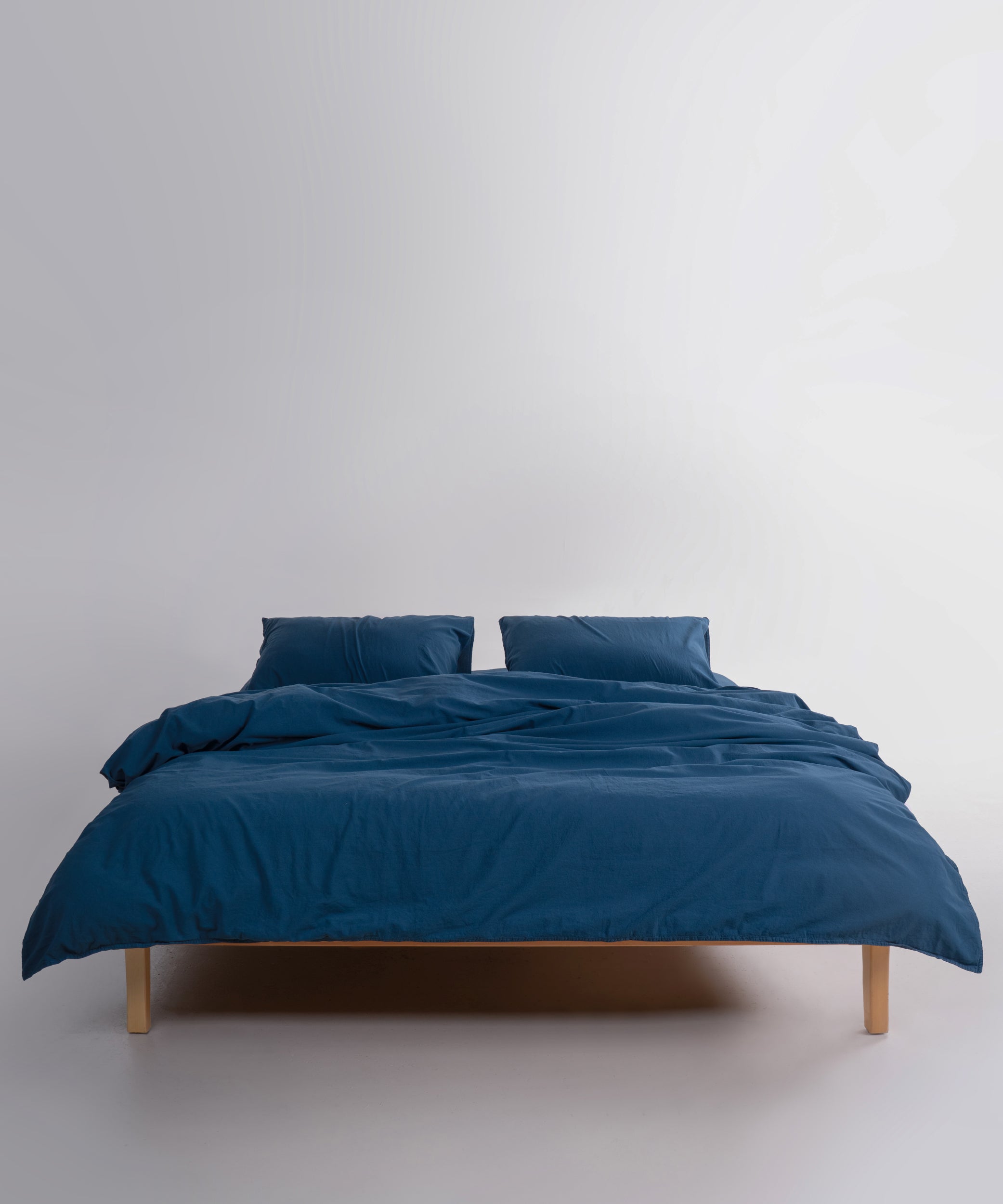 Close-up of stonewashed 100% cotton fabric in dress blue showing soft texture and breathable weave