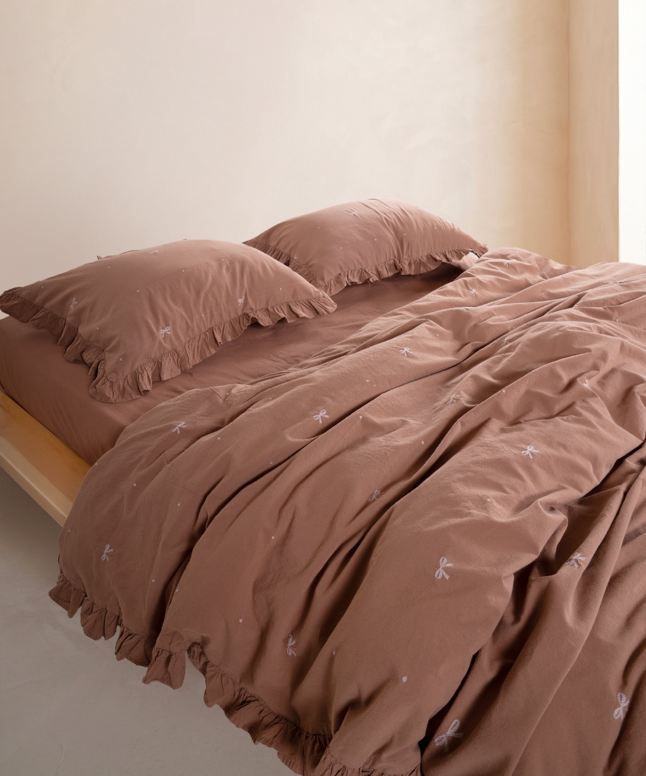 Wood Smoke stonewashed 100% cotton duvet cover set with ruffled edges styled on modern UK bed