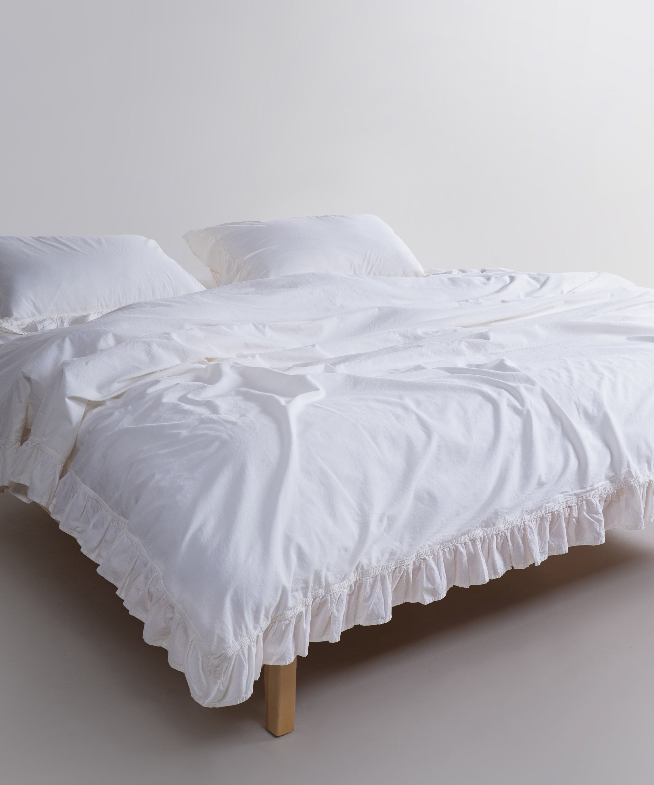 Stonewashed 100% cotton bedding with ruffle edges, breathable comfort and button closure.