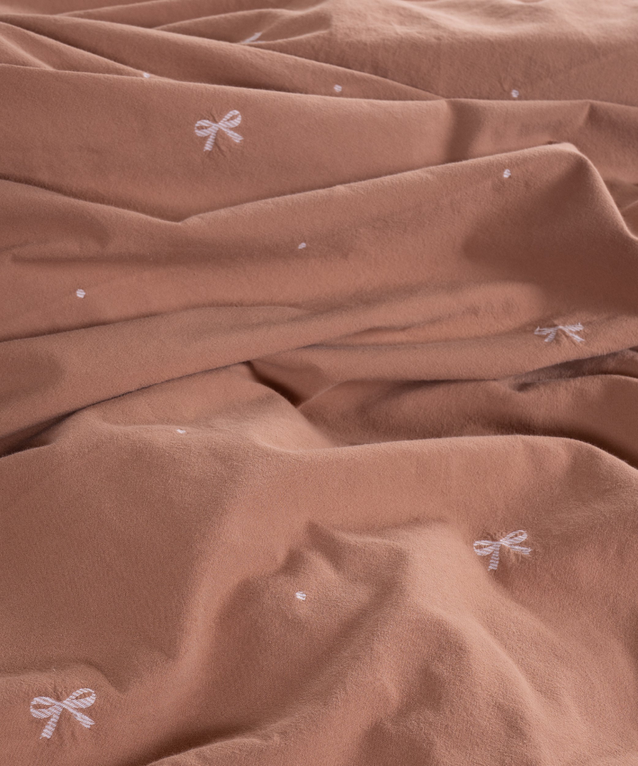 Close-up of stonewashed 100% cotton fabric in Wood Smoke showing soft breathable texture