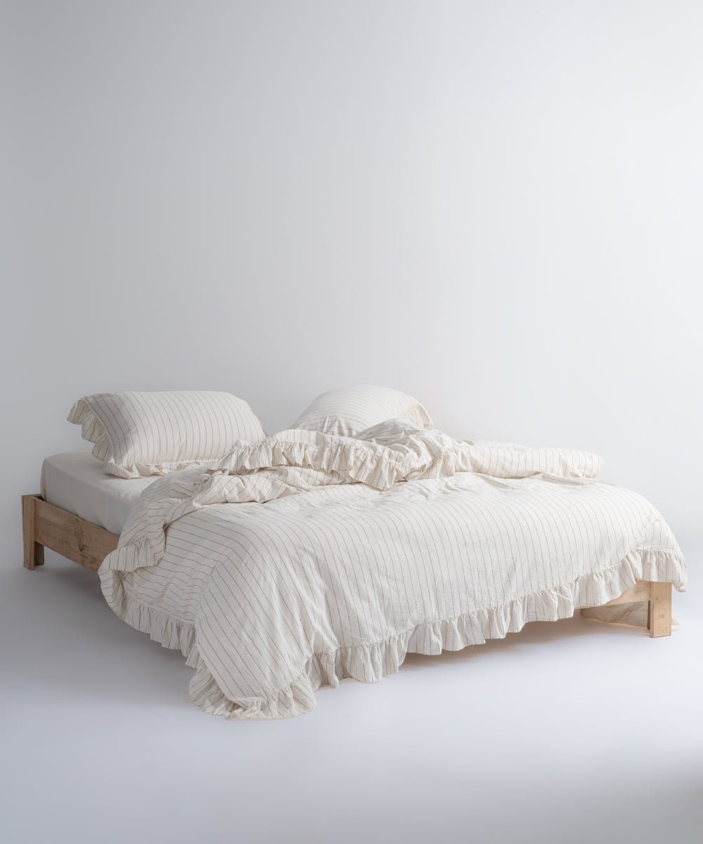 Garmenwashed Leila 100% cotton duvet cover set with natural cream fabric and black stripes, styled on a double bed
