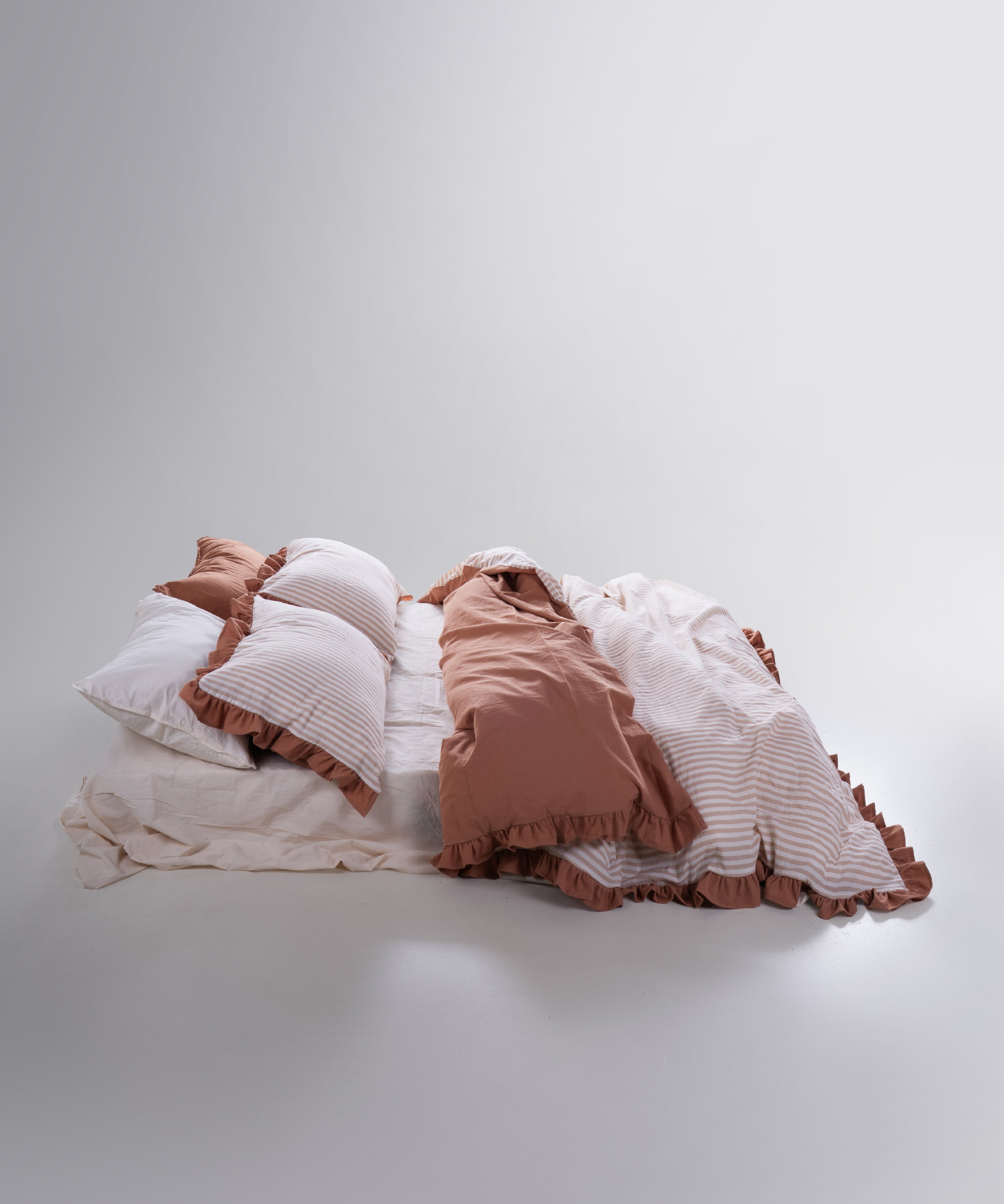 Marrakesh garment washed cotton duvet cover set styled on bed with natural cream tones