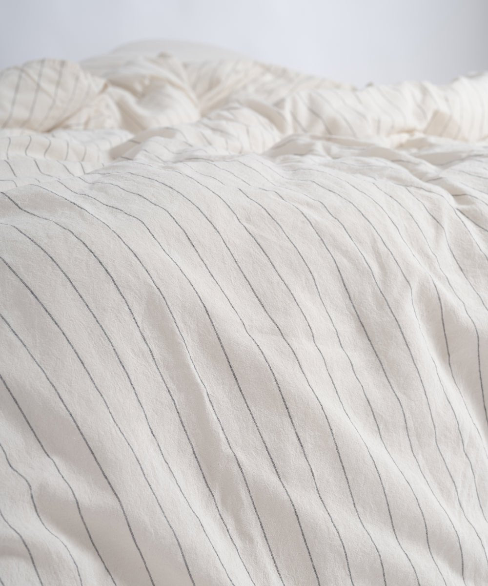 Natural cream and black striped duvet cover set in a modern UK bedroom