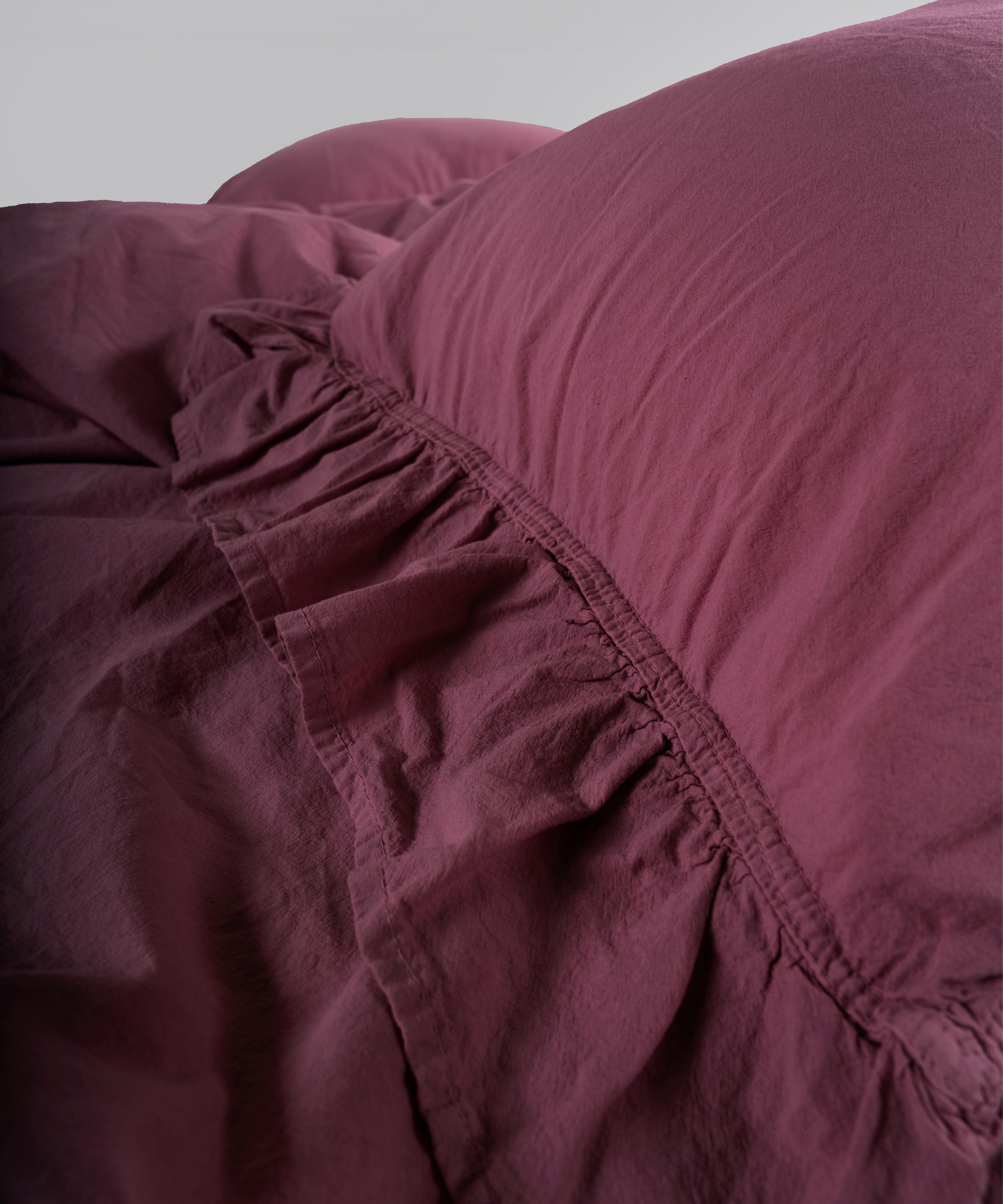 Raspberry stonewashed cotton duvet cover and pillowcase detail with envelope closure