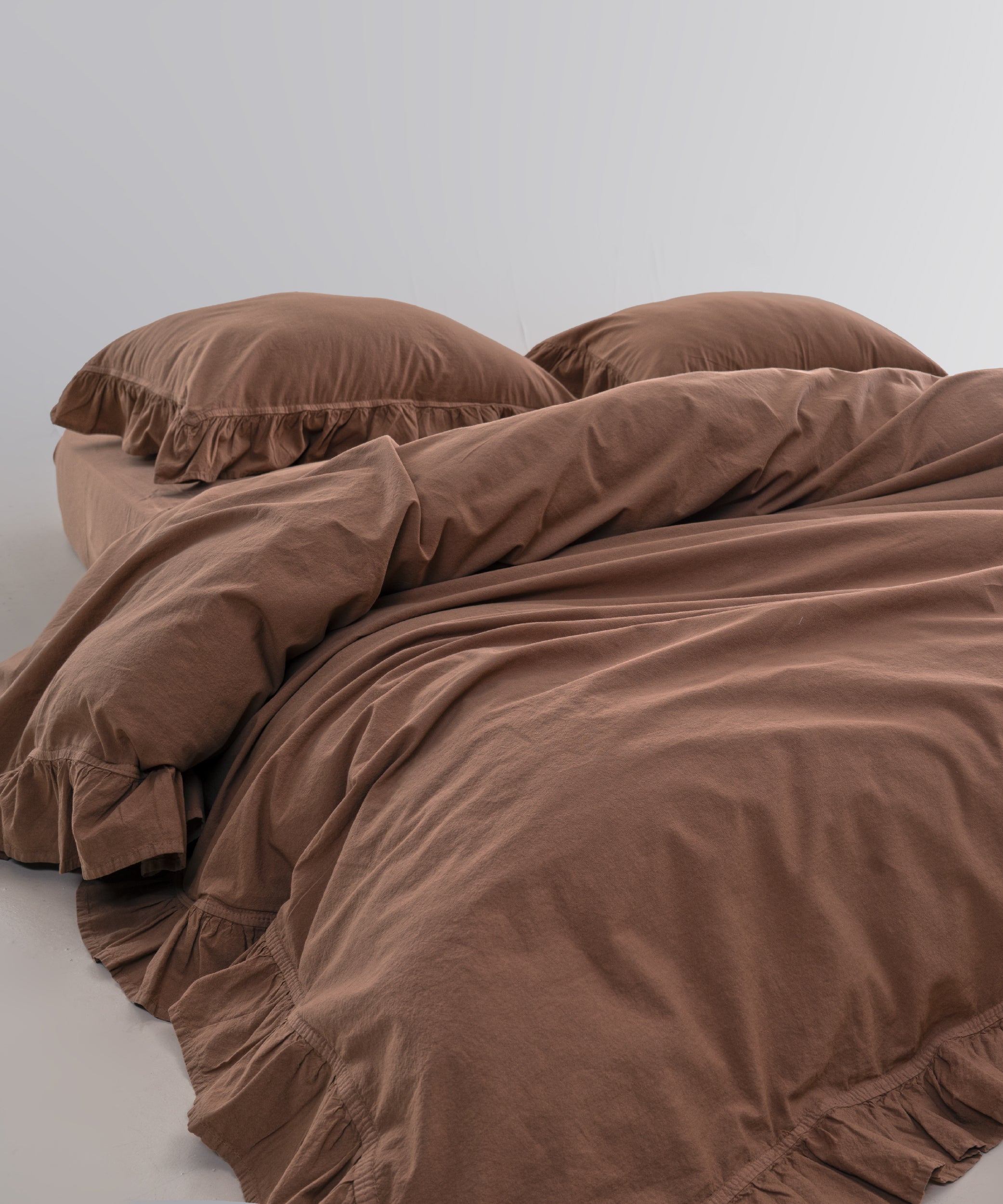 Stonewashed 100% cotton duvet cover set in wood smoke colour with soft ruffle detailing by Limasso London