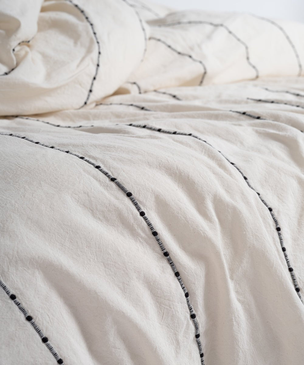 Minimalist bedroom styled with Garmenwashed Vilnuss cotton duvet cover set in natural cream colour