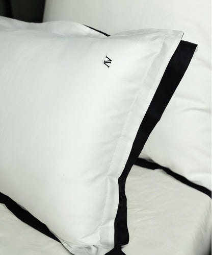 White cotton sateen Oxford pillowcase with black contrast border and elegant flange detail