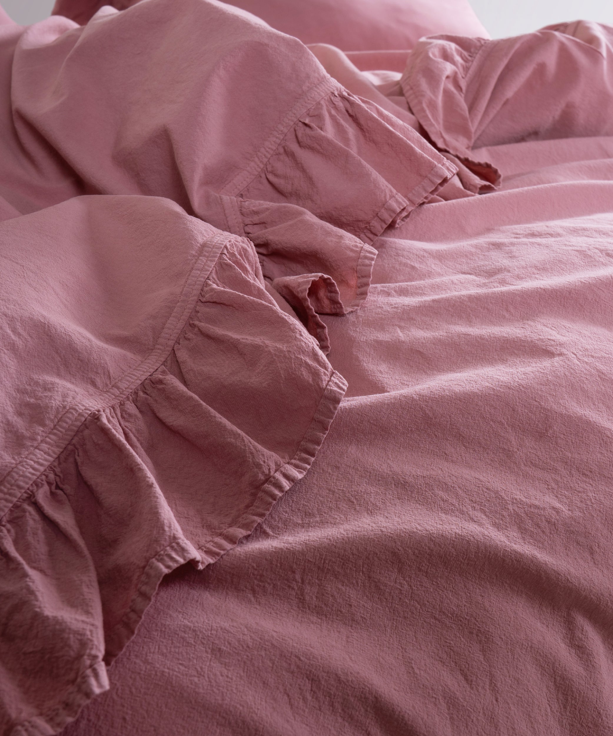 Flowing stonewashed cotton fabric in Old Rose colour showing natural drape and breathable texture