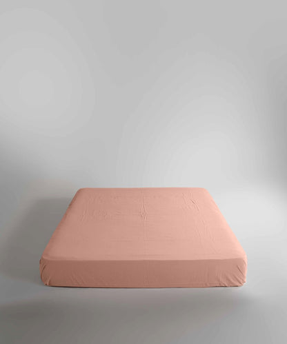 Close-up of the stonewashed cotton fitted sheet in Cameo Brown, showcasing its breathable texture, smooth finish and premium elasticated edges for a secure fit.