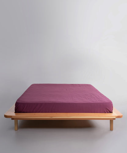 Stonewashed 100% cotton fitted sheet in Raspberry, offering a soft, breathable and relaxed finish. Designed for UK and US beds with deep fit options for a secure and stylish look.
