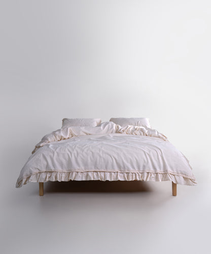 Elegant cream duvet cover set made from stonewashed cotton, styled on a double bed. The soft neutral tone adds warmth, balance and a peaceful feel to modern and classic bedrooms.