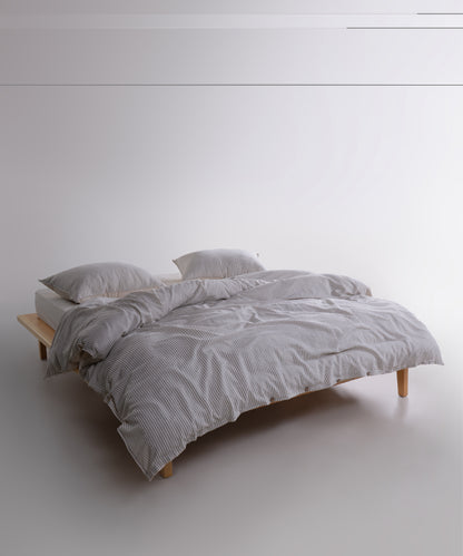 Garment washed cream cotton duvet cover set with black stripe detail styled on modern double bed