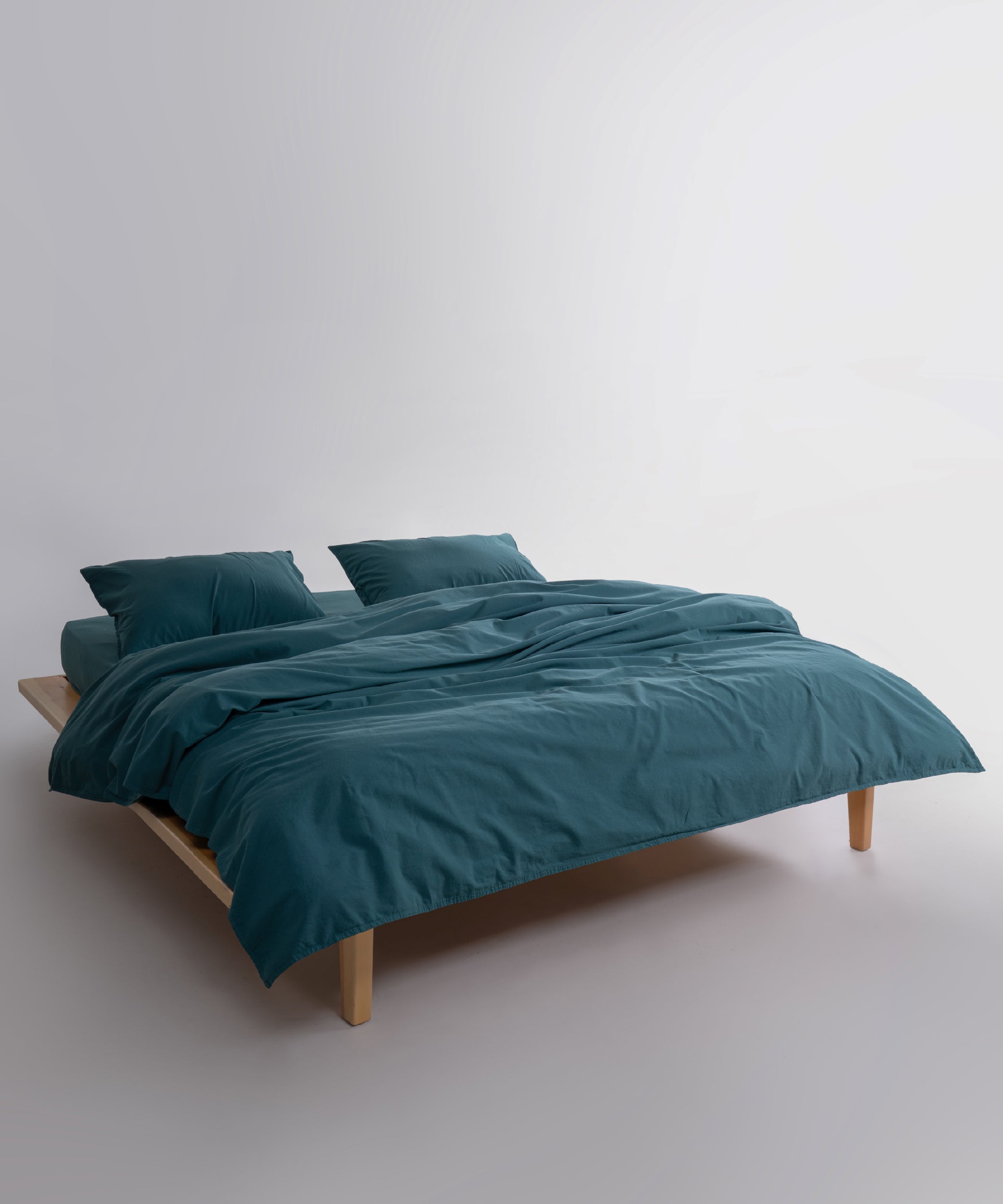 Matching dark green cotton pillowcase with envelope closure made from stonewashed 100% cotton