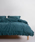 Stonewashed 100% soft cotton duvet cover set in exclusive dark green by Limasso London, styled on a UK bed