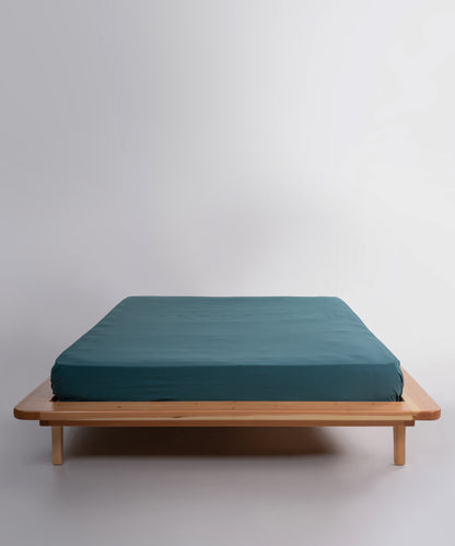 Stonewashed 100% soft cotton fitted sheet in dark green by Limasso London, designed for UK USA and Canada mattresses