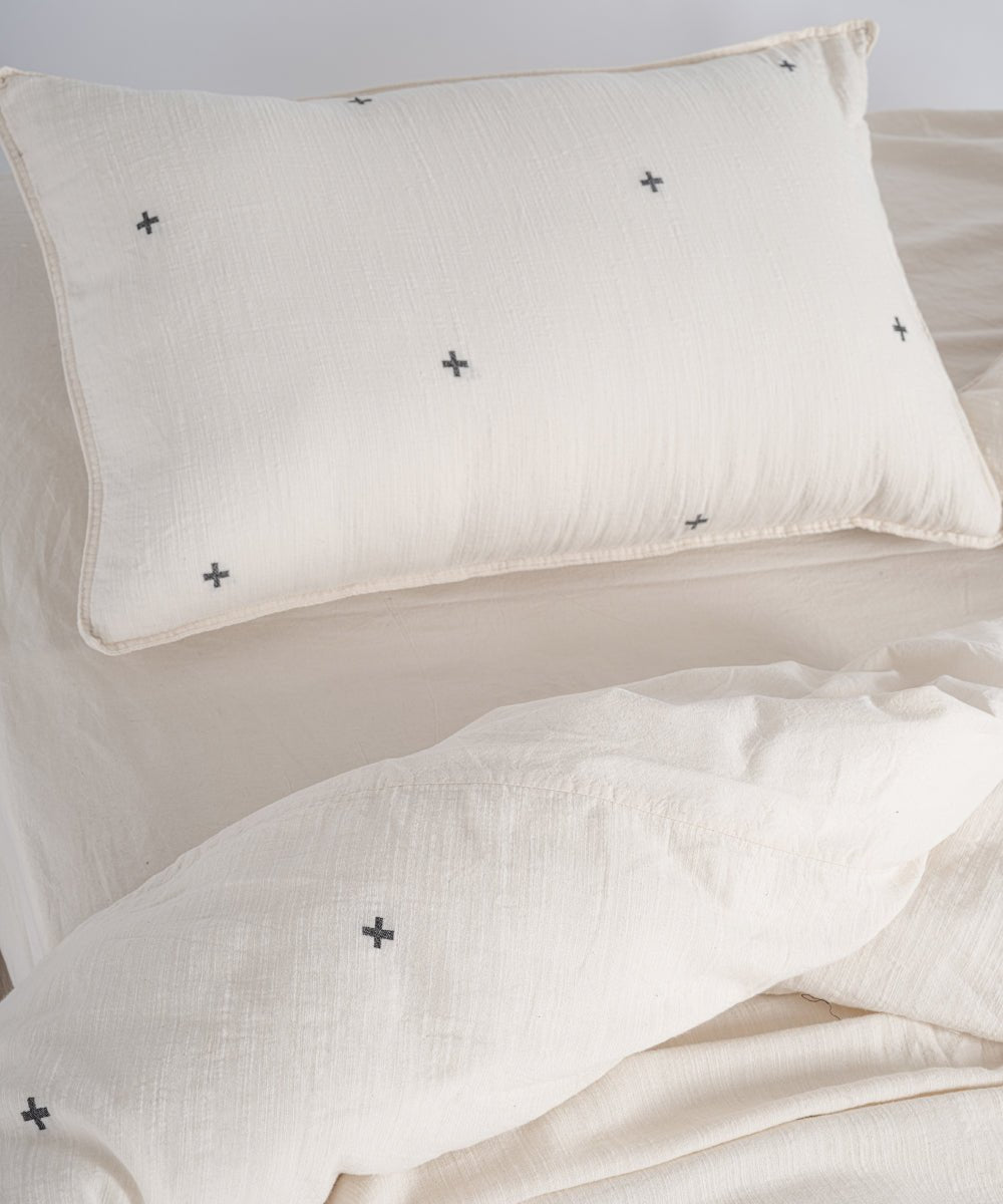Close-up of envelope closure pillowcase made from garment washed natural cotton with black cross motif