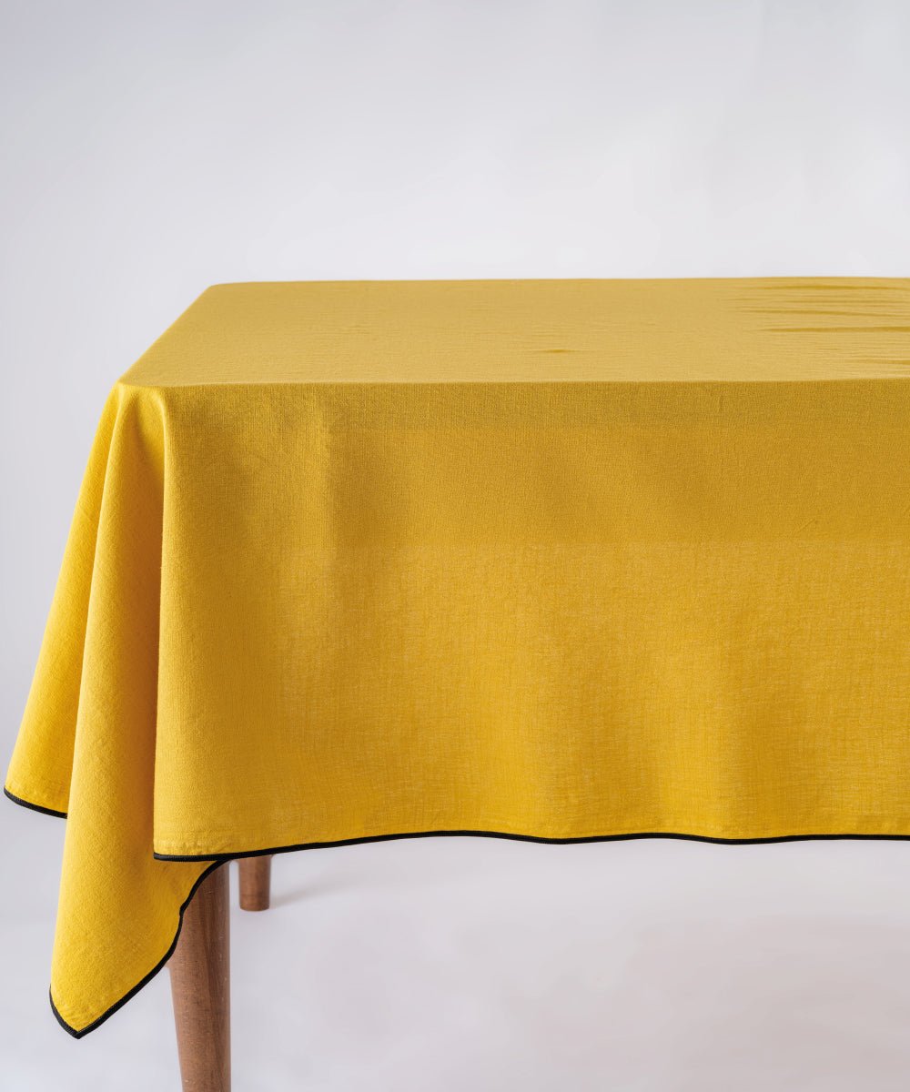 Honey stonewashed 100% cotton tablecloth with embroidered edges on rectangular dining table, soft textured dining table linen for UK homes