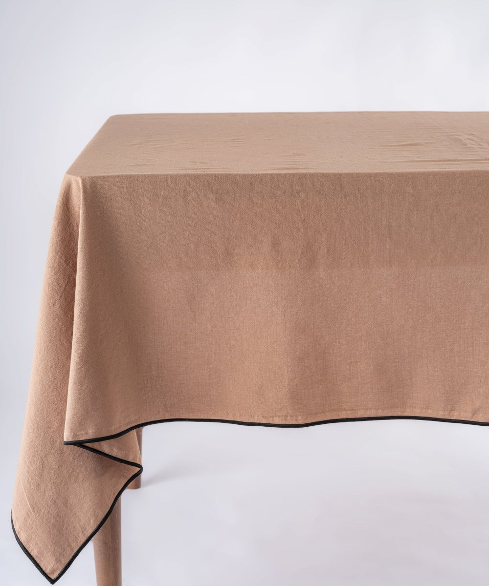 Wood Smoke stonewashed 100% cotton tablecloth with embroidered edges on rectangular dining table, soft textured grey dining table linen UK