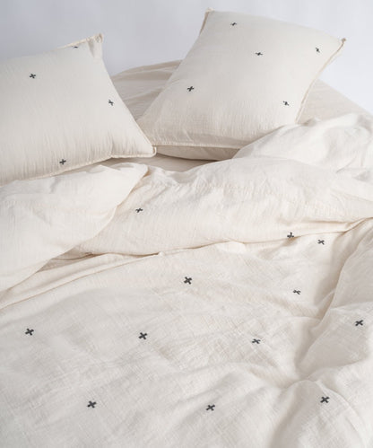 Soft natural cream cotton duvet cover set featuring modern black cross pattern, breathable and garment washed for everyday comfort
