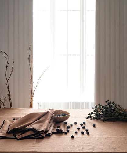 Wood Smoke grey embroidered cotton tablecloth styled on dining table with plates and decor, rectangular kitchen table cover UK