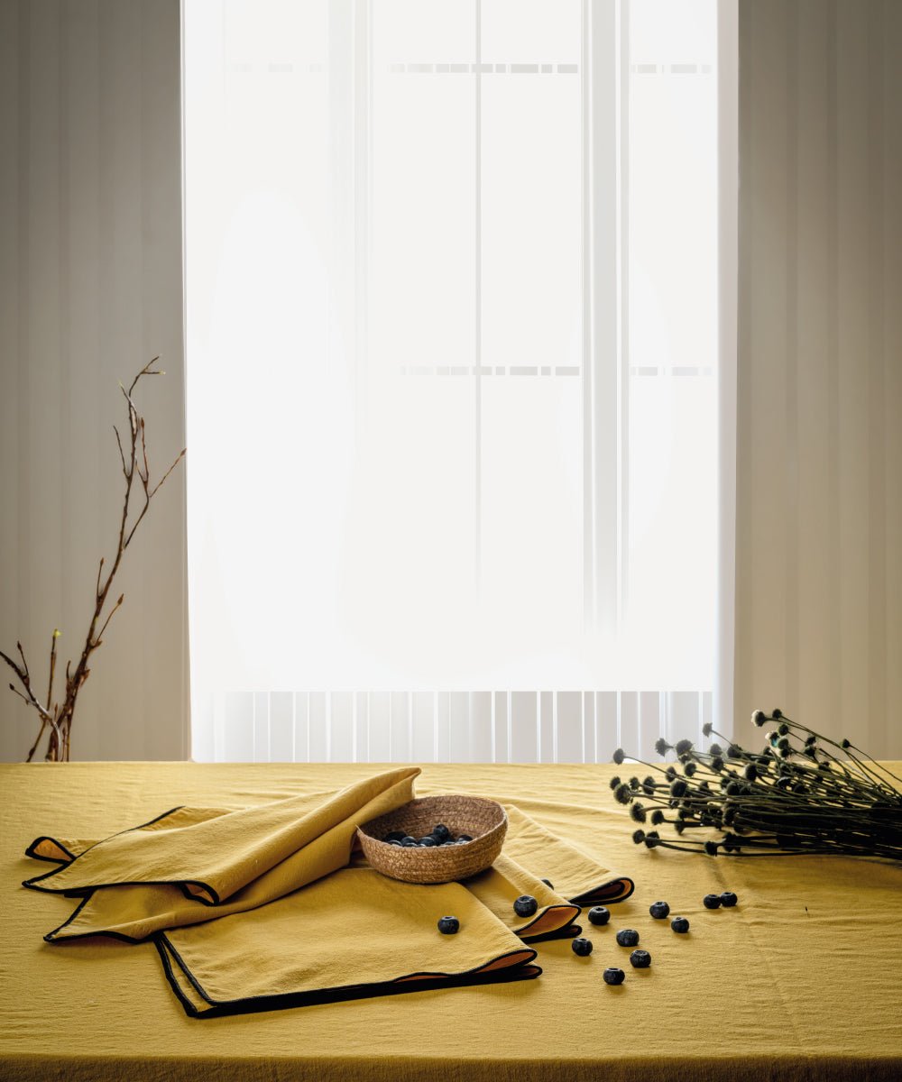 Honey embroidered cotton tablecloth styled on dining table with plates and decor, rectangular kitchen table cover UK