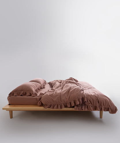 Modern UK bedroom styled with Commercer stonewashed cotton duvet cover set featuring elegant ruffled edges and soft neutral tones