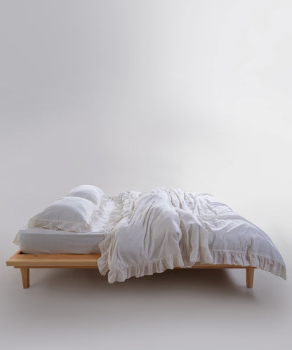 Stonewashed breathable bedding with elegant ruffle detailing for a calm, hotel-style bedroom.
