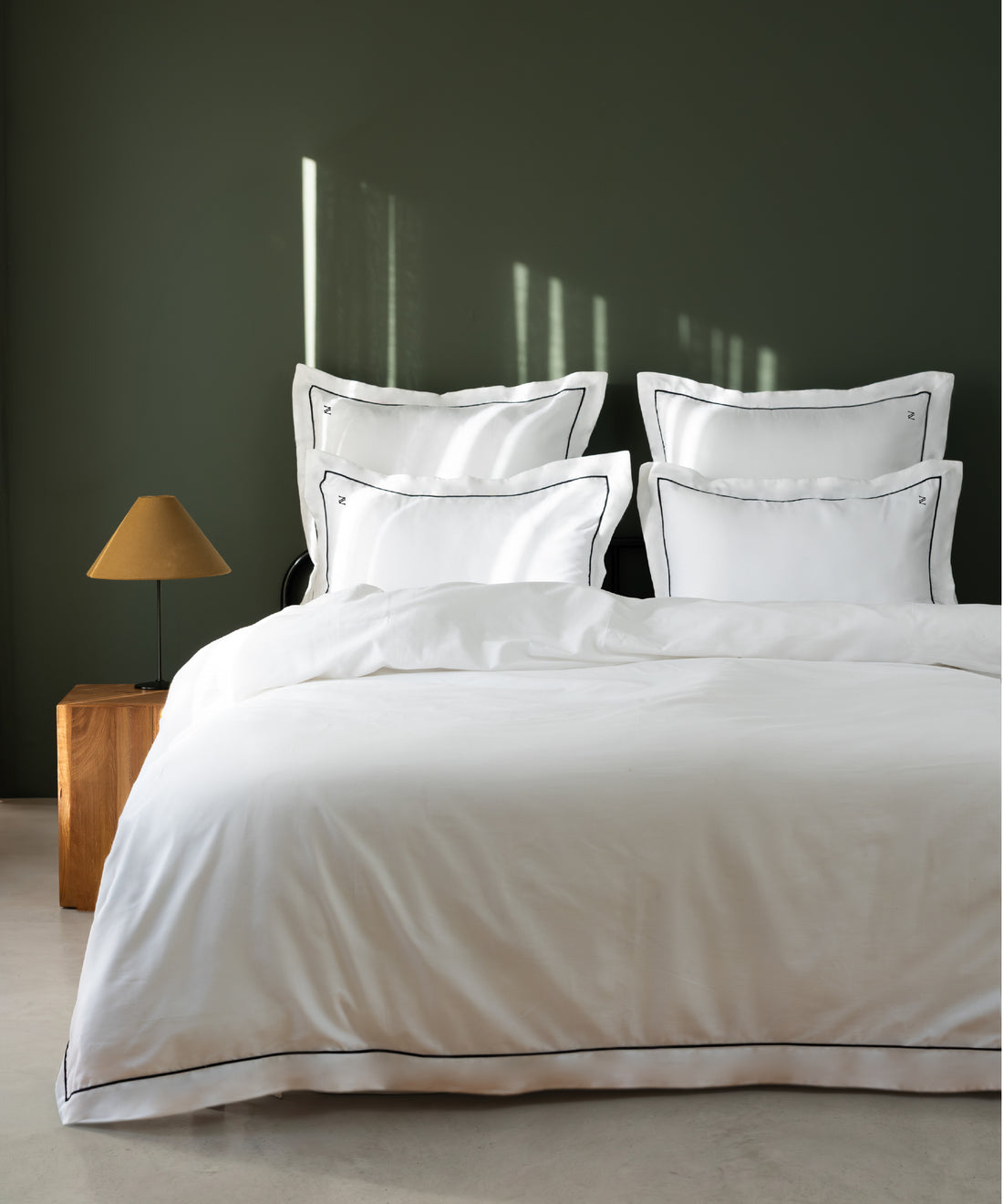 Luxury Cotton Sateen Oxford Duvet Cover Set with black contrast piping in a dark olive hotel-style bedroom – Limasso London