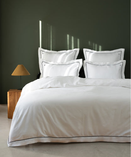 Luxury Cotton Sateen Oxford Duvet Cover Set with black contrast piping in a dark olive hotel-style bedroom – Limasso London