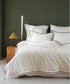 White 100% cotton sateen duvet cover set with Oxford edges and fine contrast piping styled on luxury UK bed