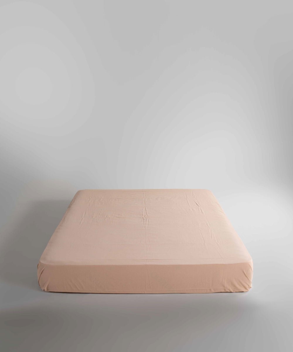 Med beige fitted sheet made from 100% stonewashed cotton, featuring elasticated corners and deep pocket options up to 40 cm for a smooth and secure fit on UK beds.