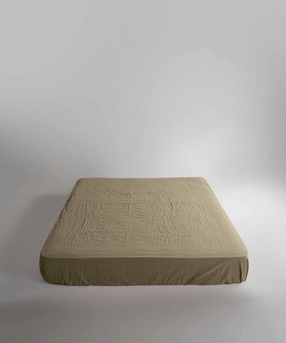 Close-up view of Limasso med green fitted sheet made from 100% stonewashed cotton. Naturally soft, breathable and ideal for everyday luxury bedding in UK homes.