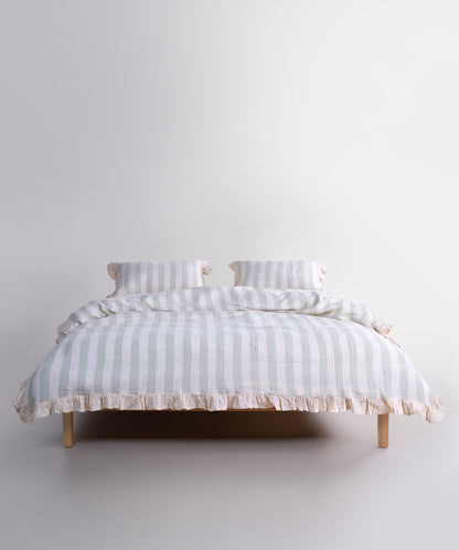 Mint striped cotton muslin duvet cover set displayed on bed, garment washed breathable bedding with natural cream base