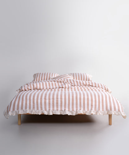 Mustard striped cotton muslin duvet cover set displayed on bed, breathable garment washed bedding with natural cream base