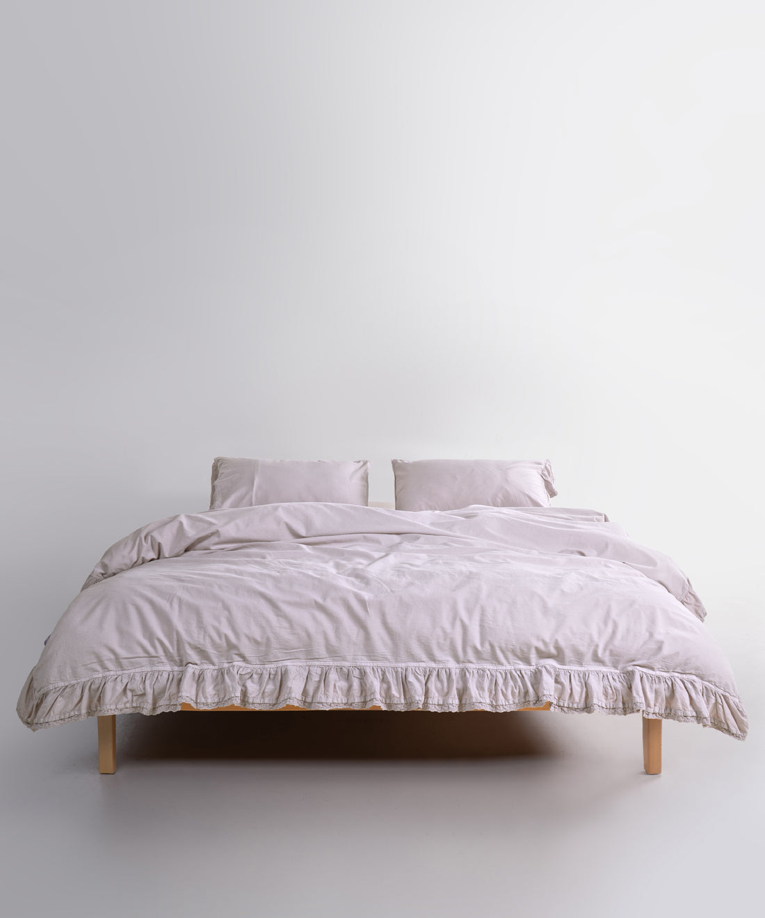 Close up of Sicilia Natura Cream stonewashed cotton duvet cover with elegant ruffle lace trim detail