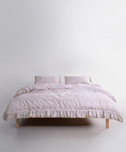 Close up of Sicilia Natura Cream stonewashed cotton duvet cover with elegant ruffle lace trim detail