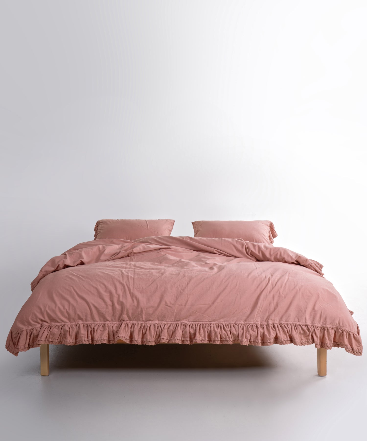 Close up of Sicilia New Rose stonewashed cotton duvet cover with elegant ruffle lace trim detail