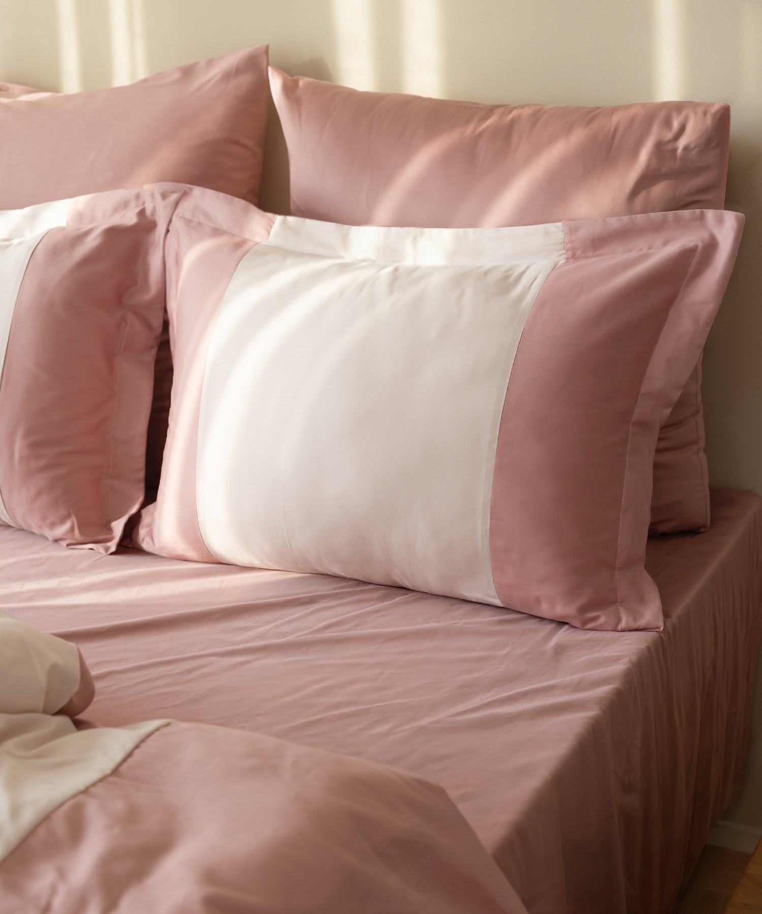 Close-up of 210TC Sateen Oxford pillowcases in Old Rose and Pale Mauve showing silky sateen sheen and border detail