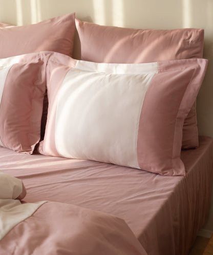 Close-up of 210TC Sateen Oxford pillowcases in Old Rose and Pale Mauve showing silky sateen sheen and border detail