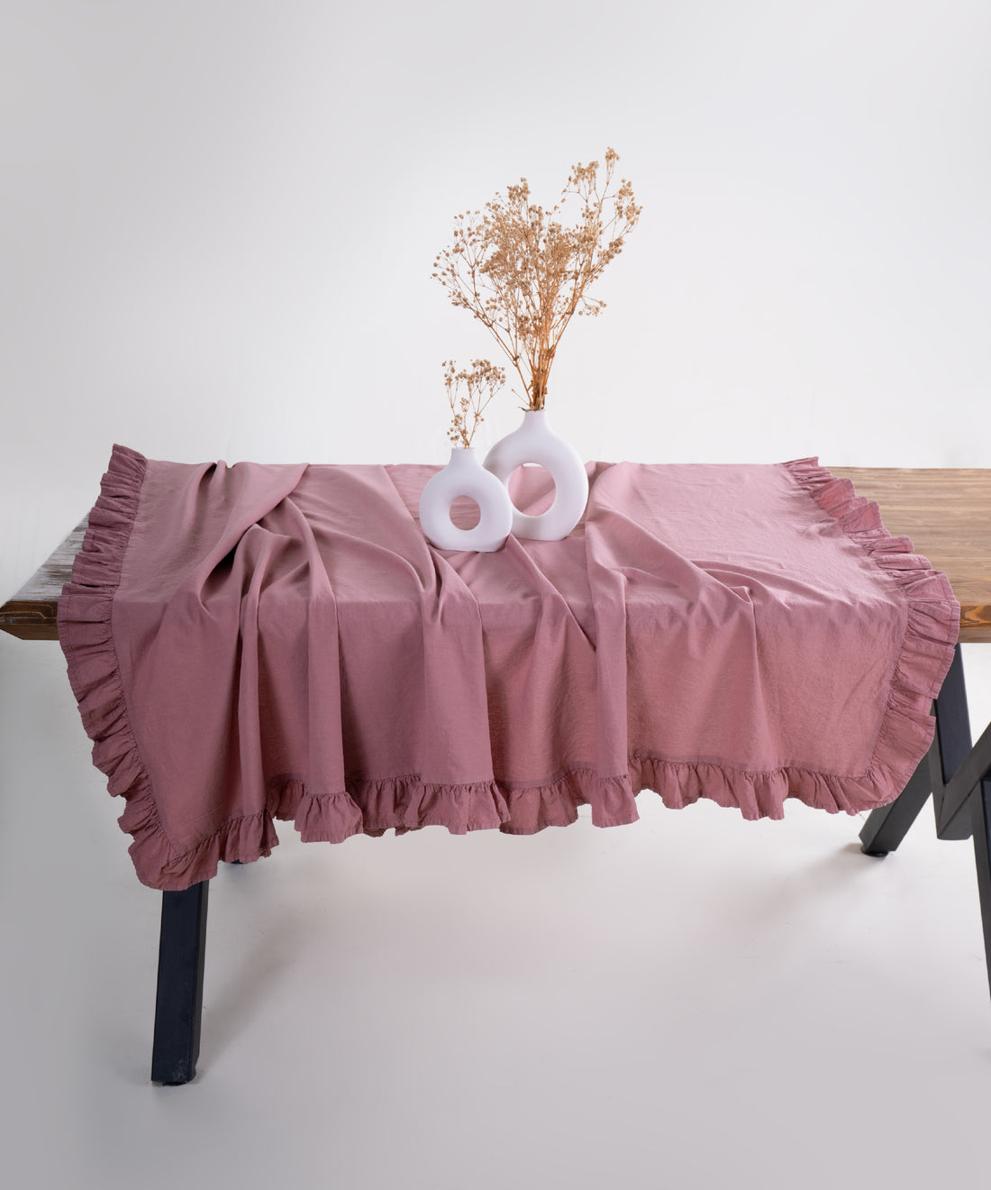 Old Rose pink embroidered ruffle edge cotton tablecloth styled on dining table with plates and decor, UK kitchen table cover