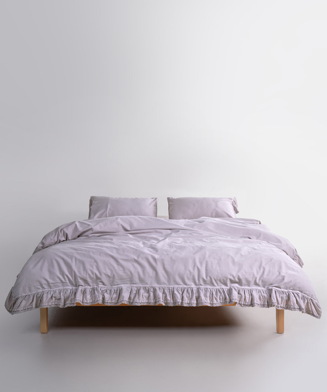 Close up of Sicilia Opal Grey stonewashed cotton duvet cover with elegant ruffle lace trim detail
