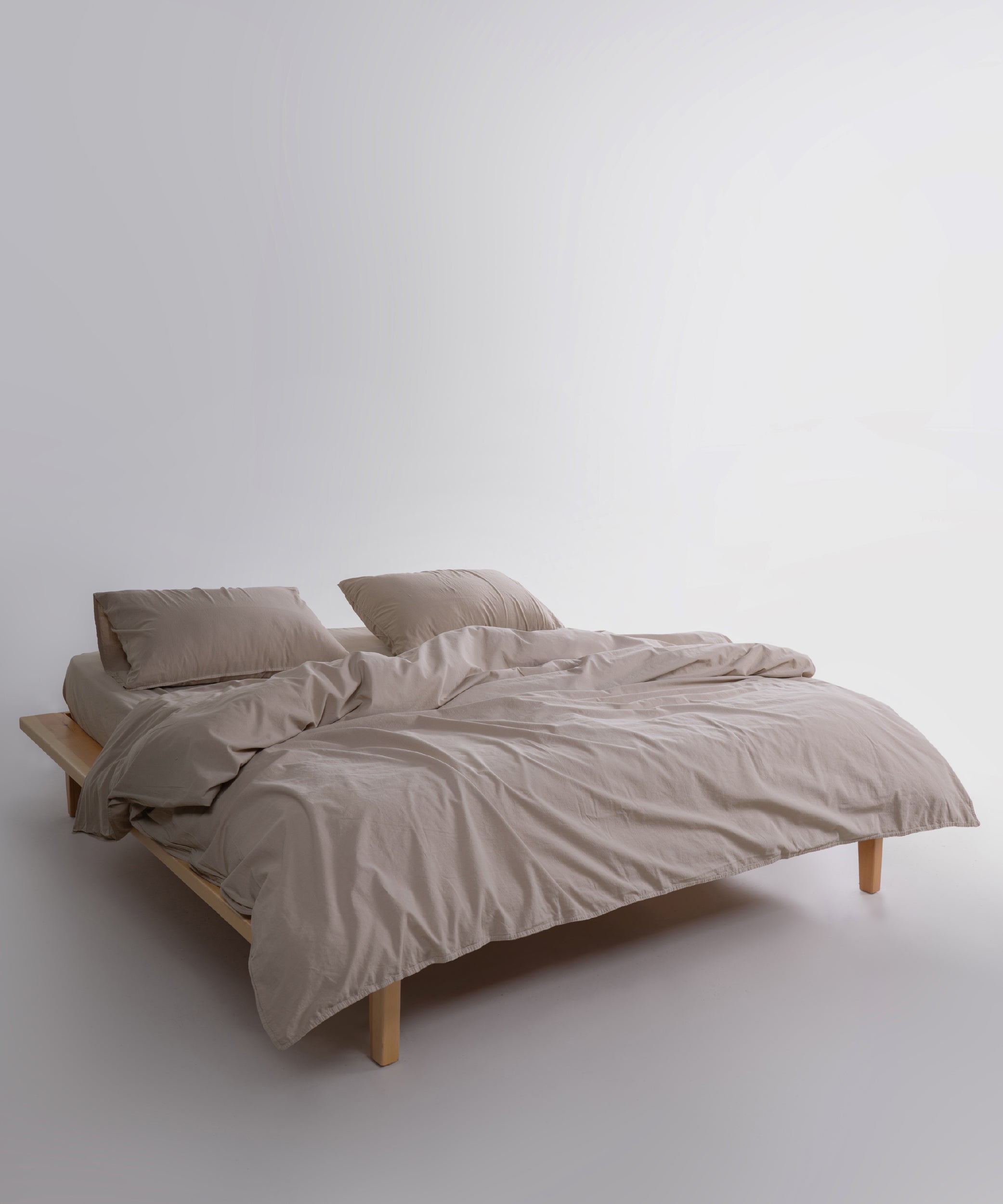 Beige stonewashed cotton duvet cover and pillowcases styled on a calm modern UK USA and Canada bedroom