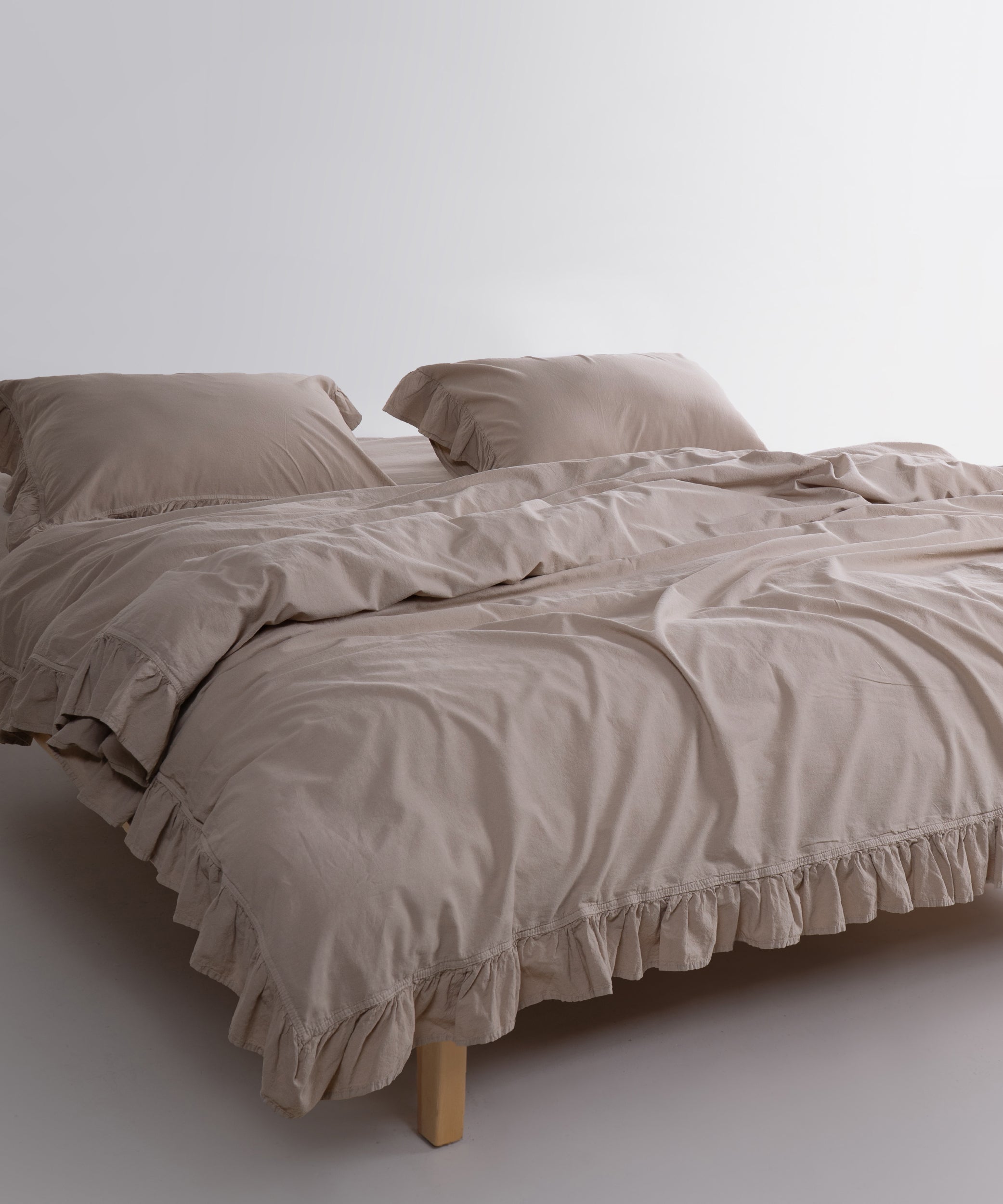 Neutral oxfordtan beige cotton pillowcases styled on a modern UK and USA bedroom bed